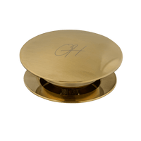 Gouden Flusso afvoerplug van Ostiumhome® – alleen het bovenaanzicht van de zichtbare dop in luxueuze afwerking